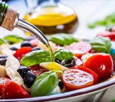 How the Mediterranean Diet with olive oil shields the human body against COVID-19