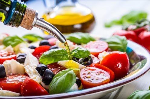 How the Mediterranean Diet with olive oil shields the human body against COVID-19